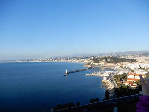 A large body of water with a city in the background

Description automatically generated