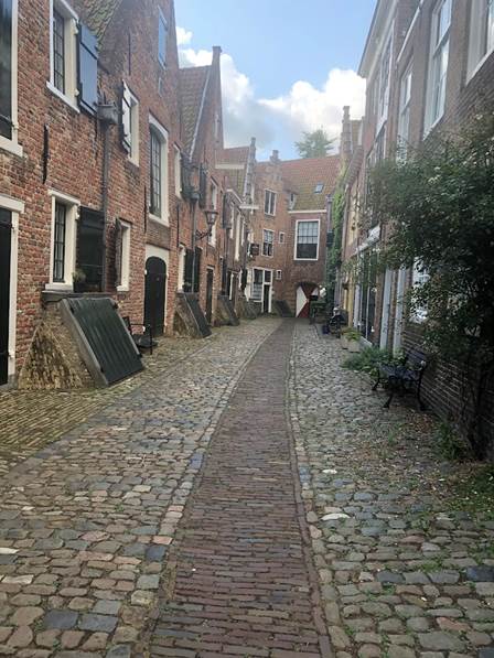 A cobblestone street between buildings

Description automatically generated with medium confidence