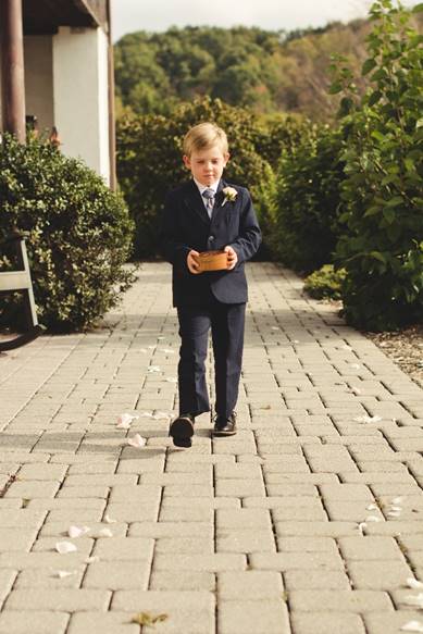 A young boy standing on a sidewalk

Description automatically generated